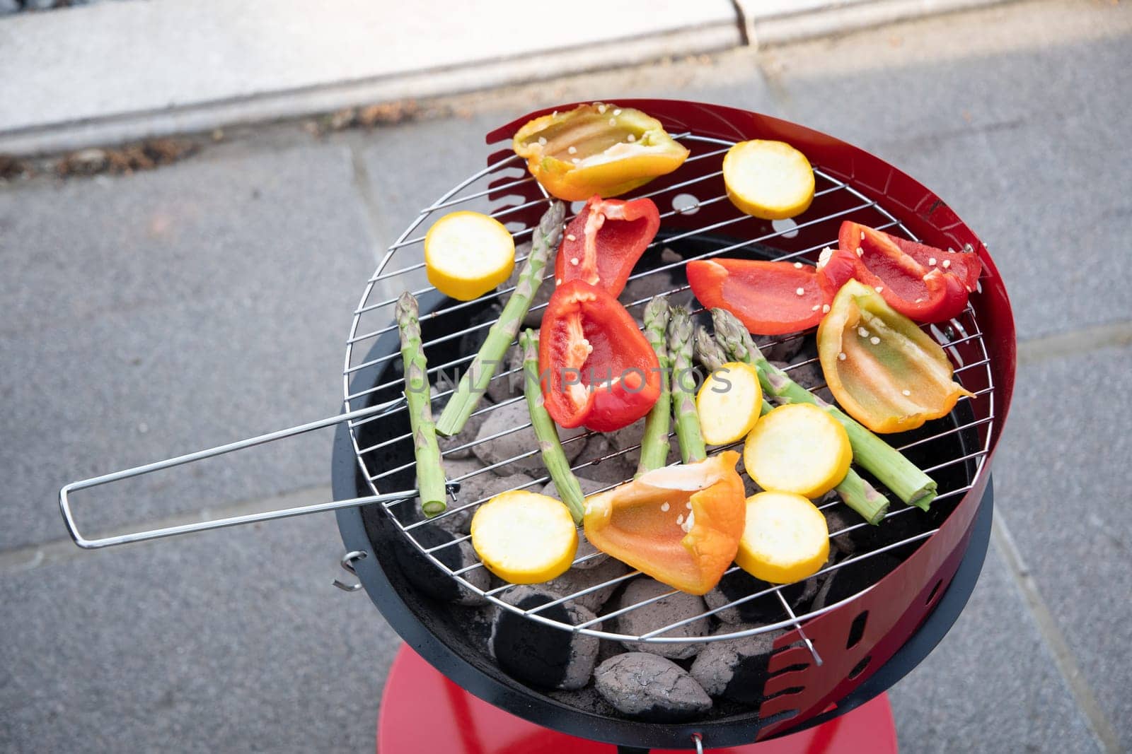 barbecue of colorful raw vegetables on a grill on blue shabby boards, vegetarian food, delicious vegan food, summer picnics. High quality photo