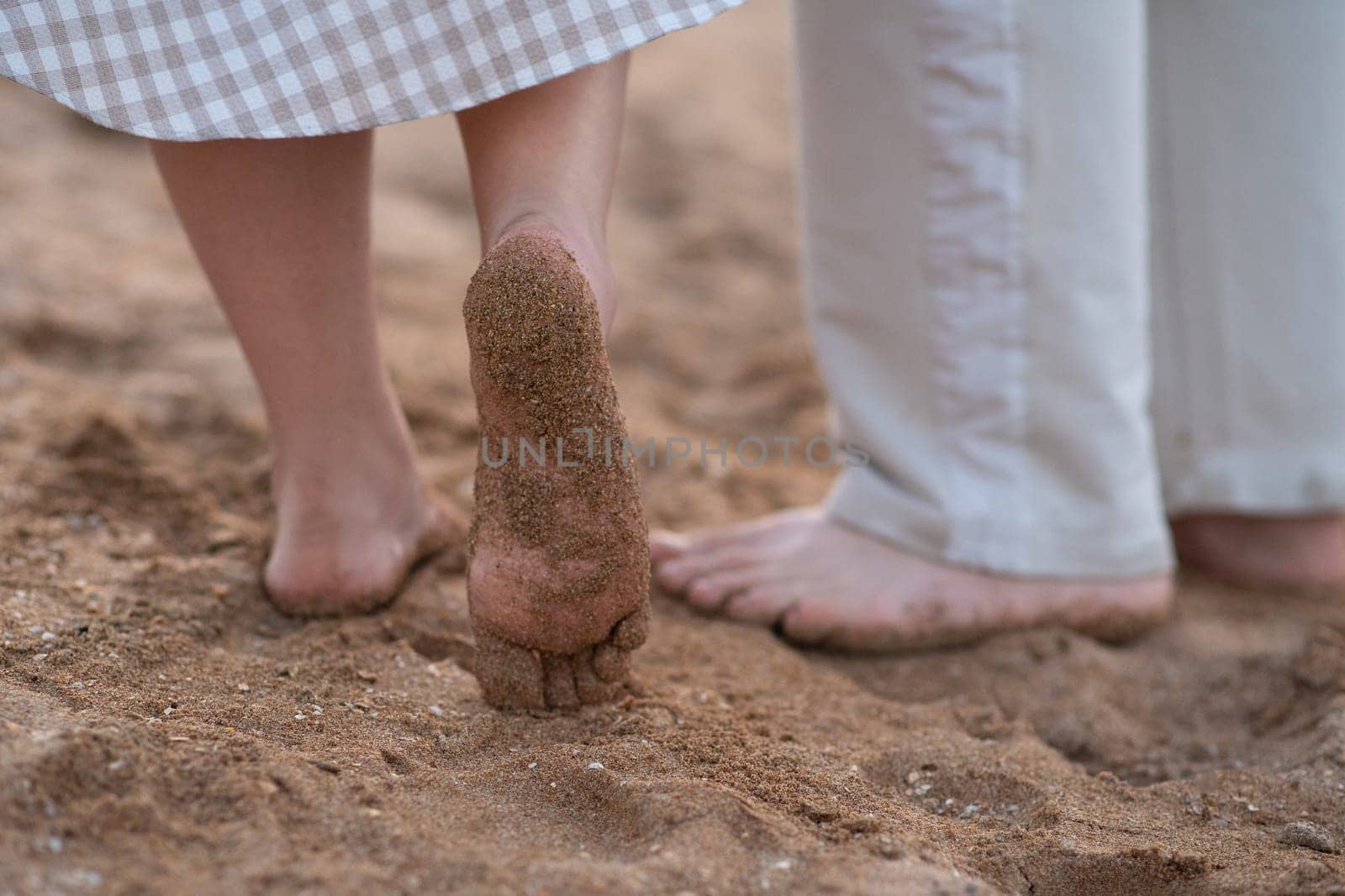 Sand on the feet and heels on the coast