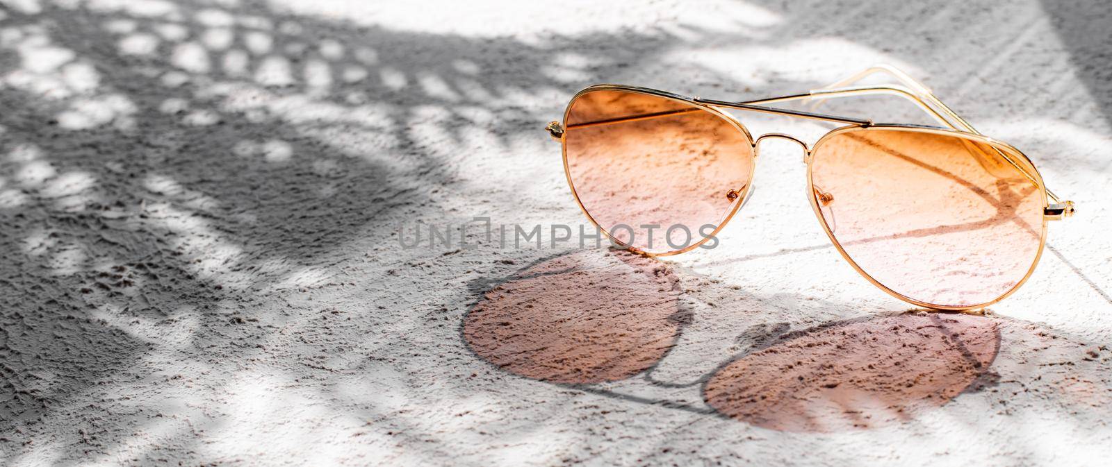 Sunglasses with sun shadows . Summer layout. Women's sunglasses. Sun protection. Copy space
