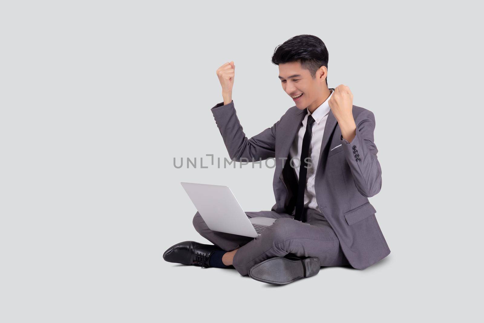 Young asian business man sitting work on laptop computer to internet online isolated on white background, businessman confident and notebook, freelance with success, marketing and communication. by nnudoo