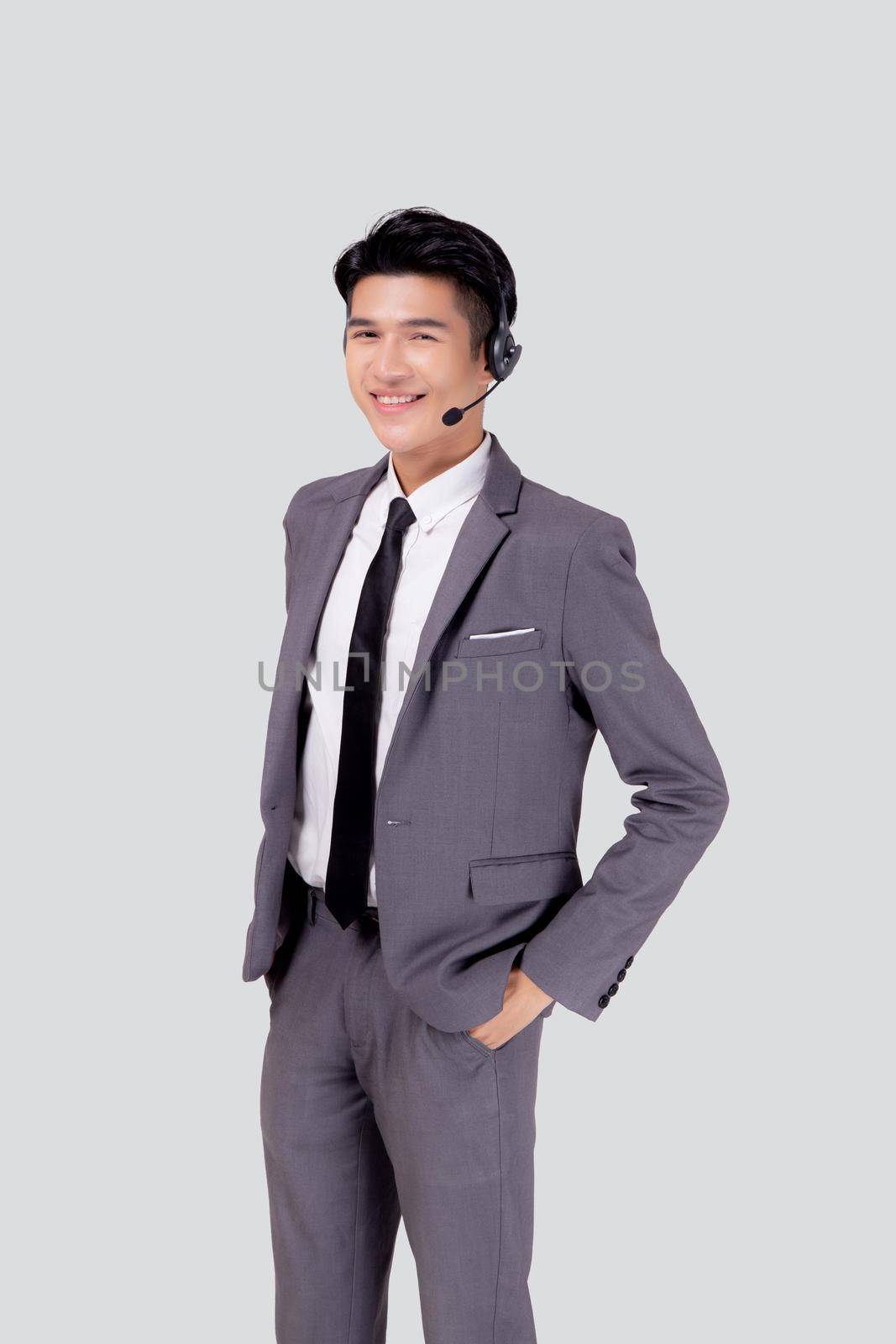 Portrait young asian business man call center wearing headset isolated on white background, agent with support and service, businessman is assistant for client with phone or helpline online. by nnudoo