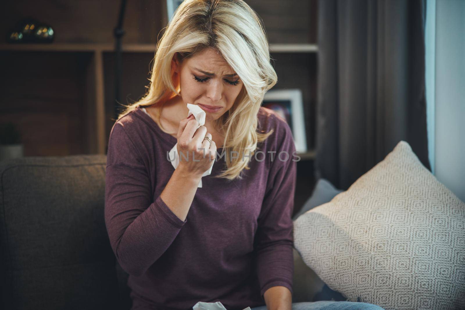Shot of a an attractive young woman looking depressed and sadness while sitting on the sofa and crying at home.