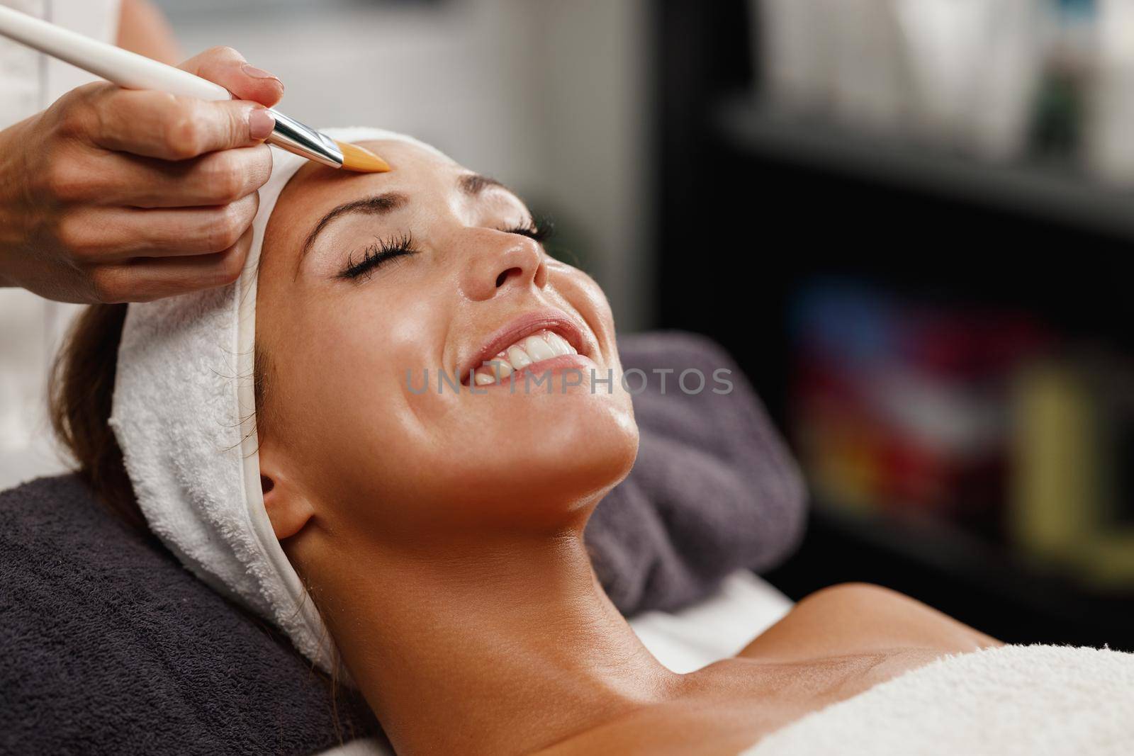 Shot of a beautiful young woman getting a facial mask treatment at the beauty salon.