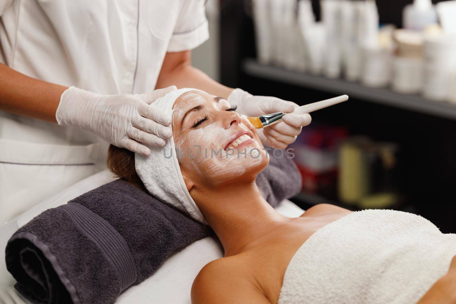 Shot of a beautiful young woman getting a facial mask treatment at the beauty salon.