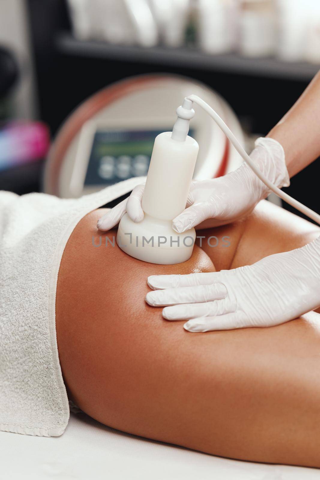 Shot of a unrecognizable woman getting a anti cellulite massage at the beauty salon. She have a ultrasound cavitacion treatment to fat reduction.
