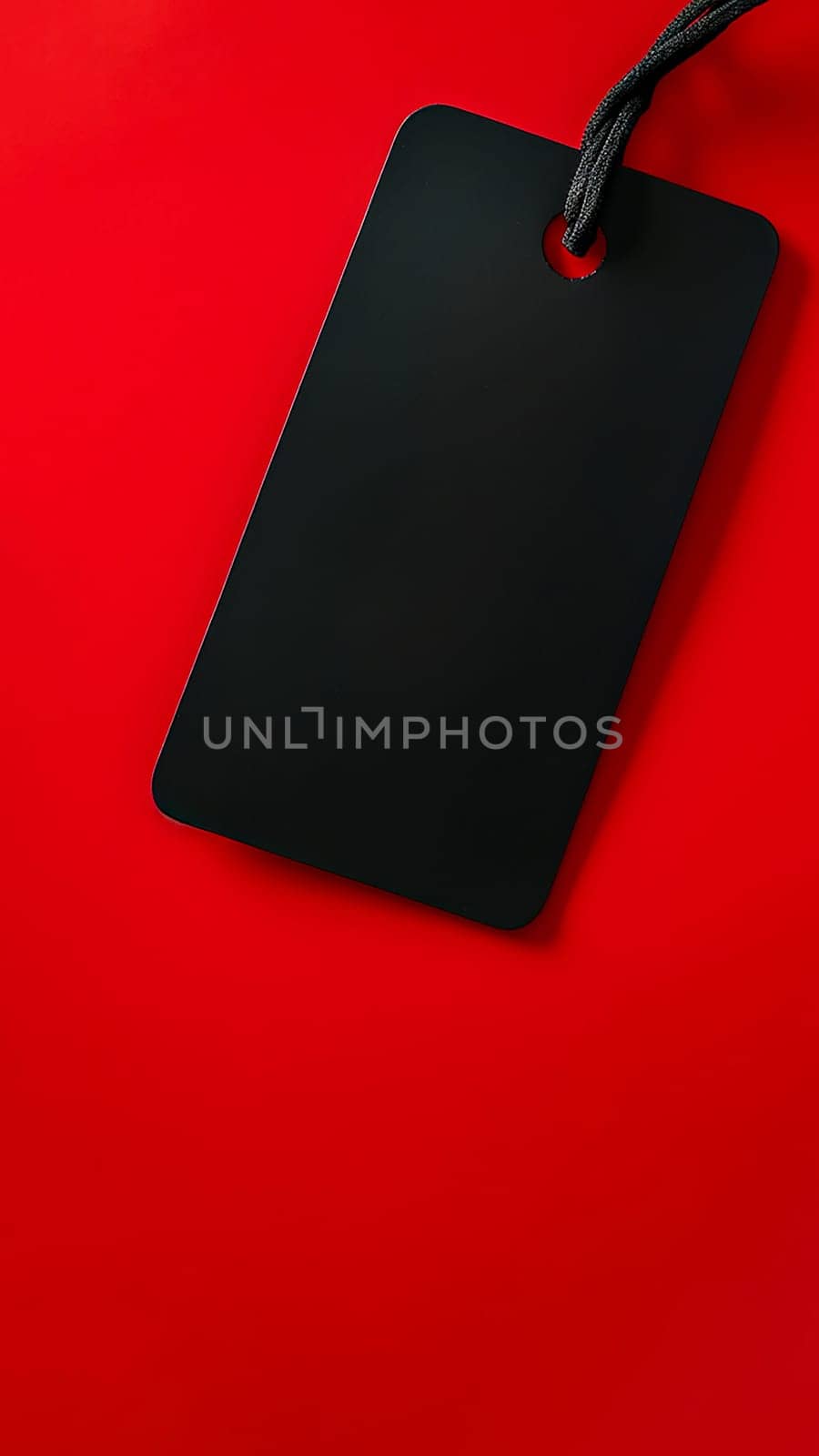 Black empty price tag on red background. Black Friday concept, template copyspace.