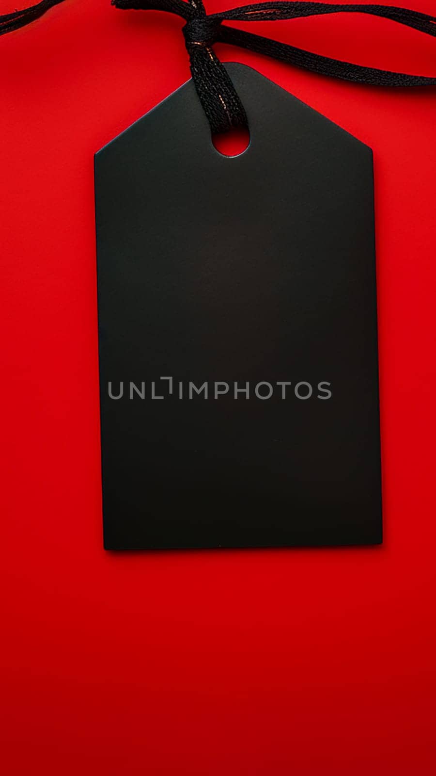 Black empty price tag on red background. Black Friday concept, template copyspace by ijeab