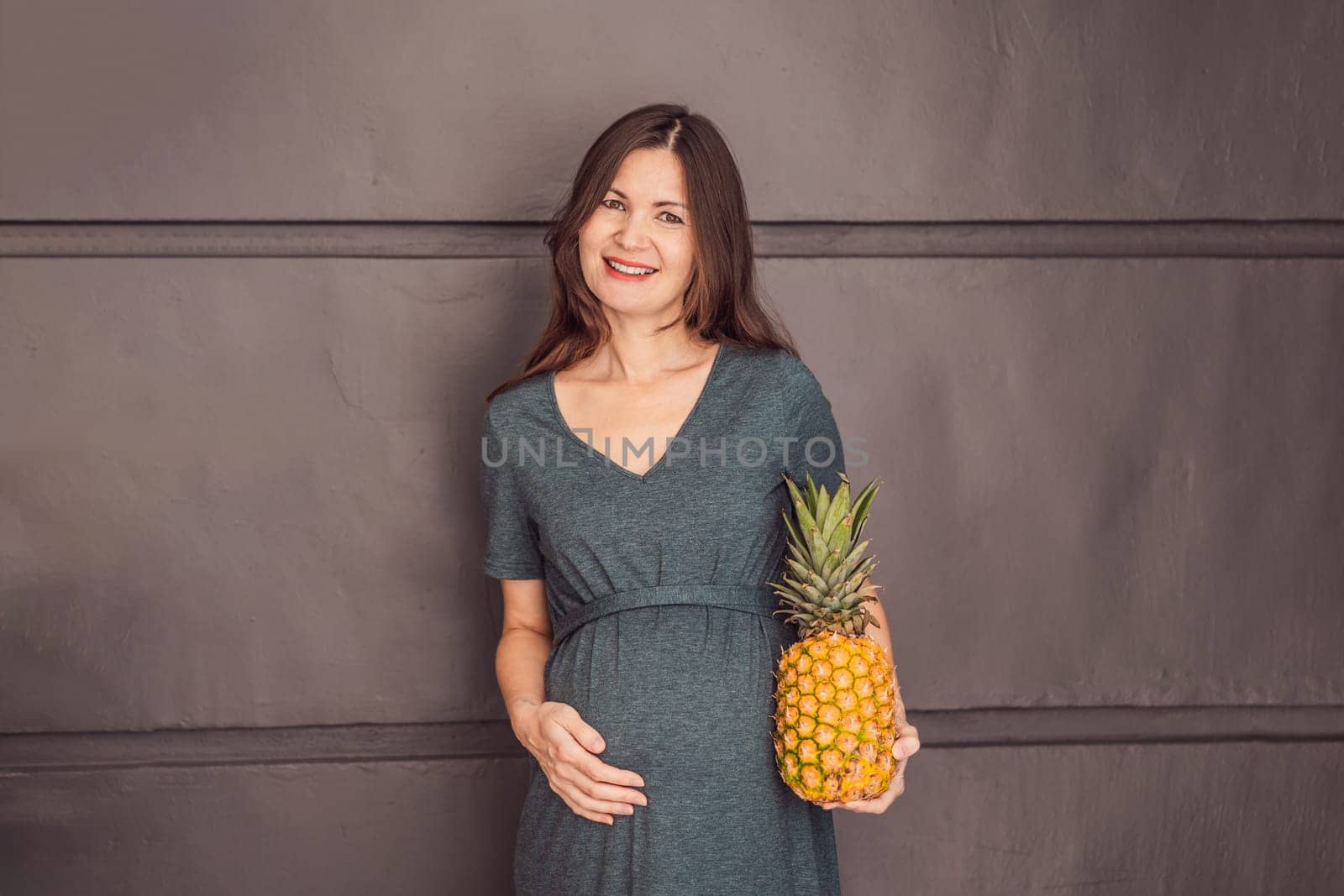 A pregnant woman's belly, beautifully showcasing the size of her baby, likened to a pineapple. Explore the potential benefits and harms of pineapple during pregnancy and childbirth.