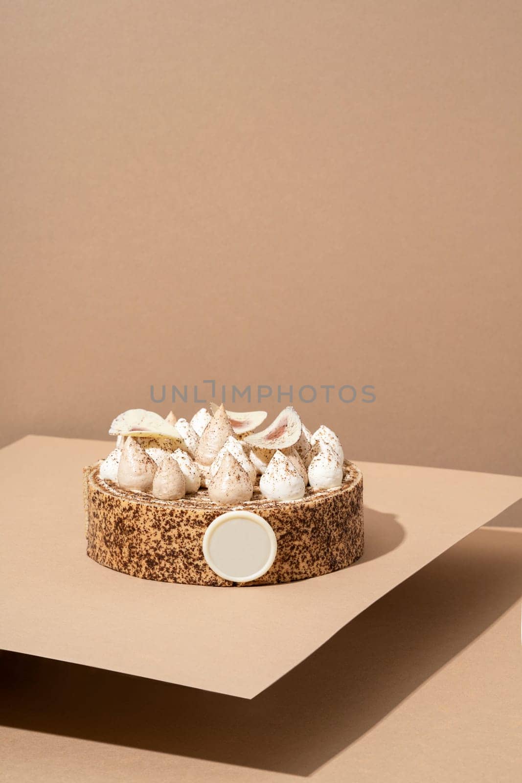 A scrumptious desert plate featuring a meringue desert, served on a cardboard plate and topped with cream by A_Karim
