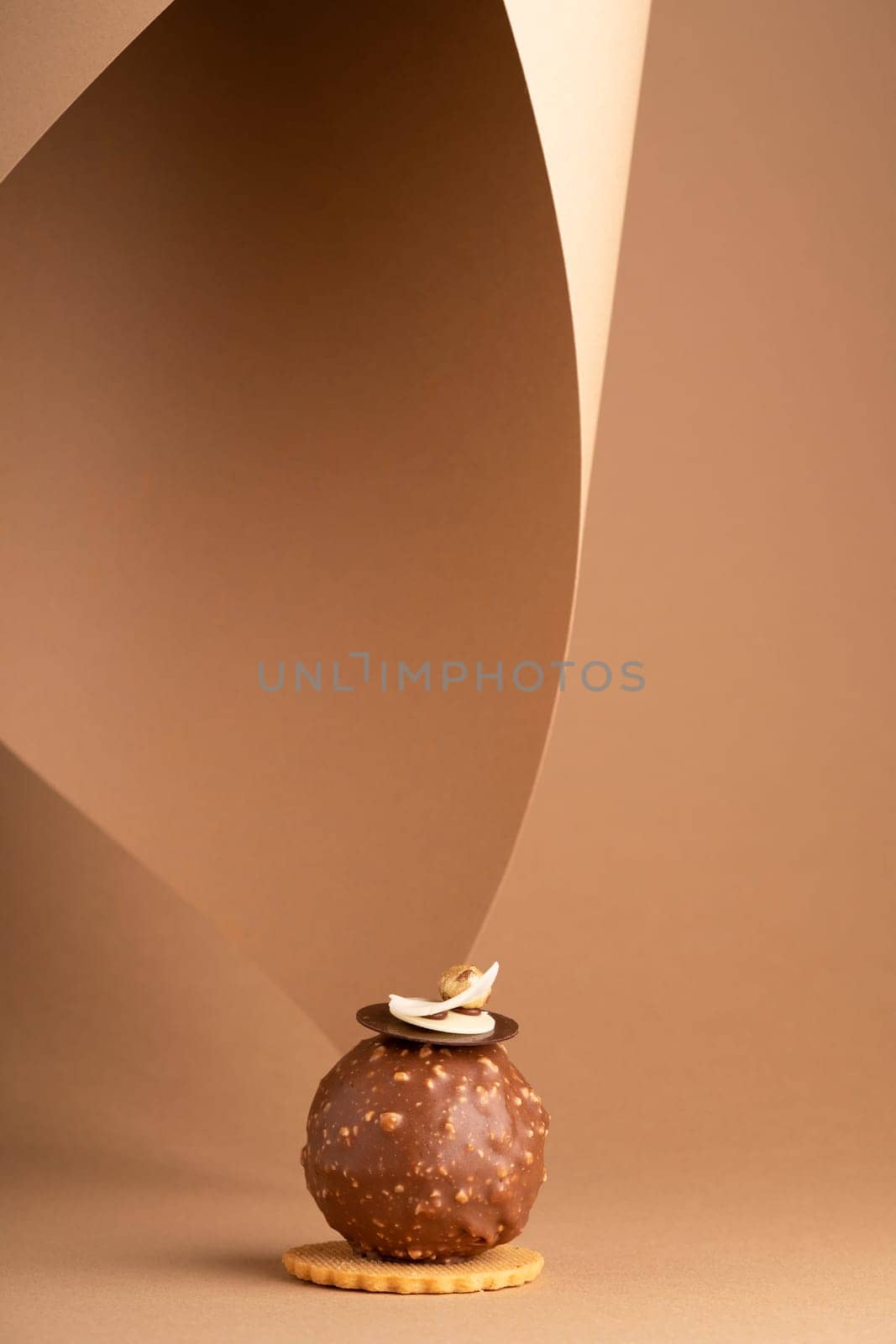 A decadent chocolate cake on a piece of parchment paper, ready to be enjoyed by A_Karim