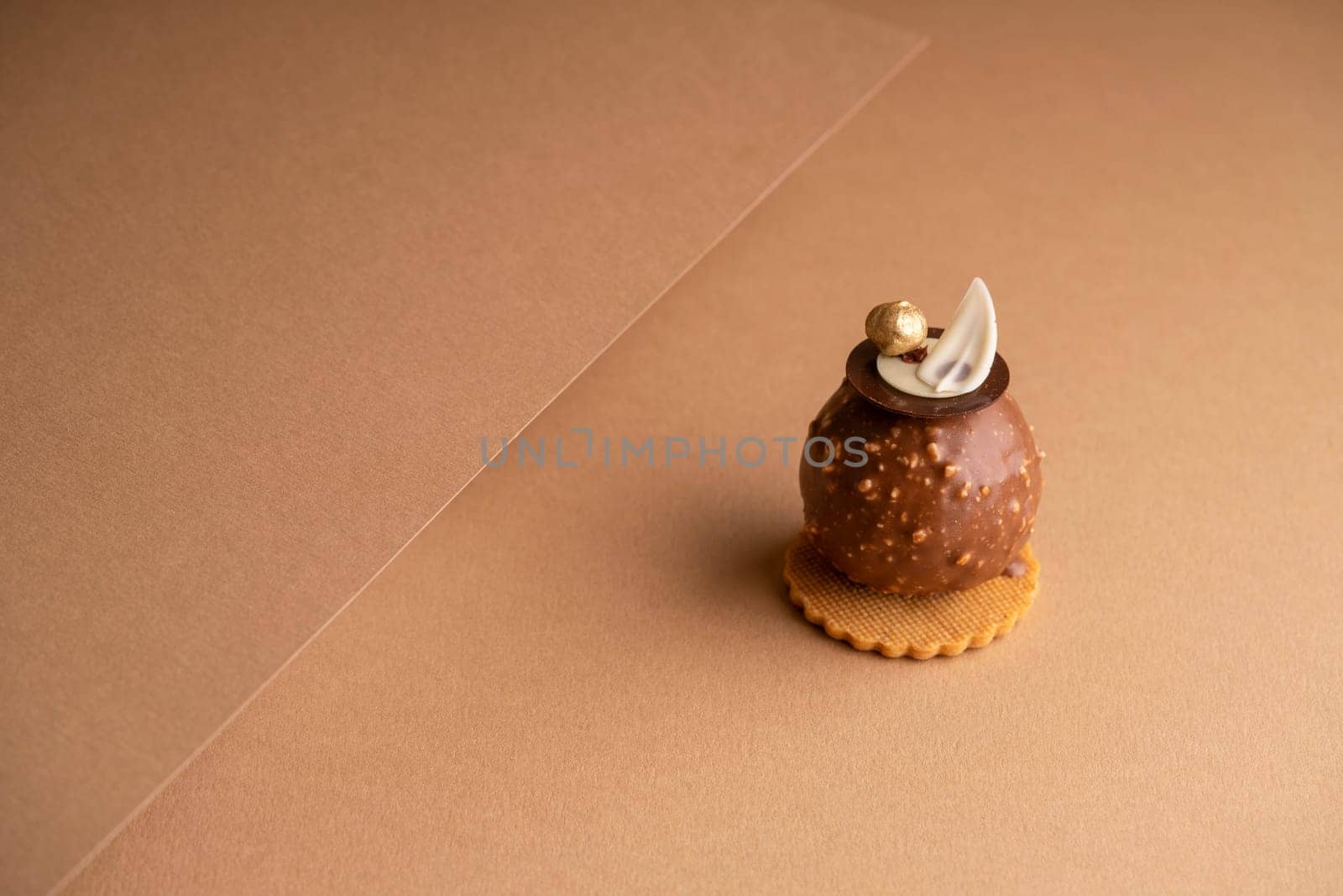 A freshly-baked cake sits atop a table, surrounded by sheets of parchment pape