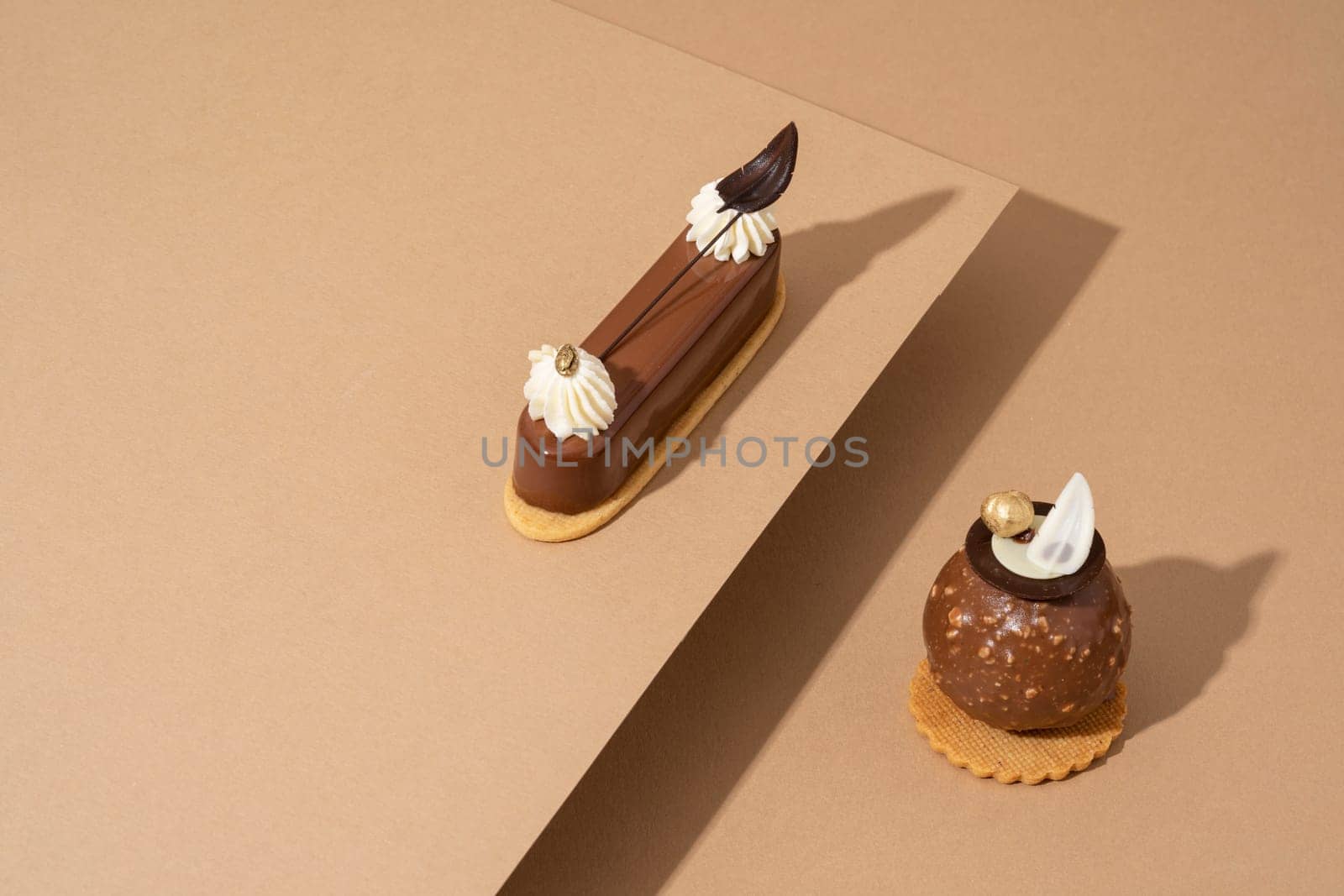 A freshly-baked cake sits atop a table, surrounded by sheets of parchment pape