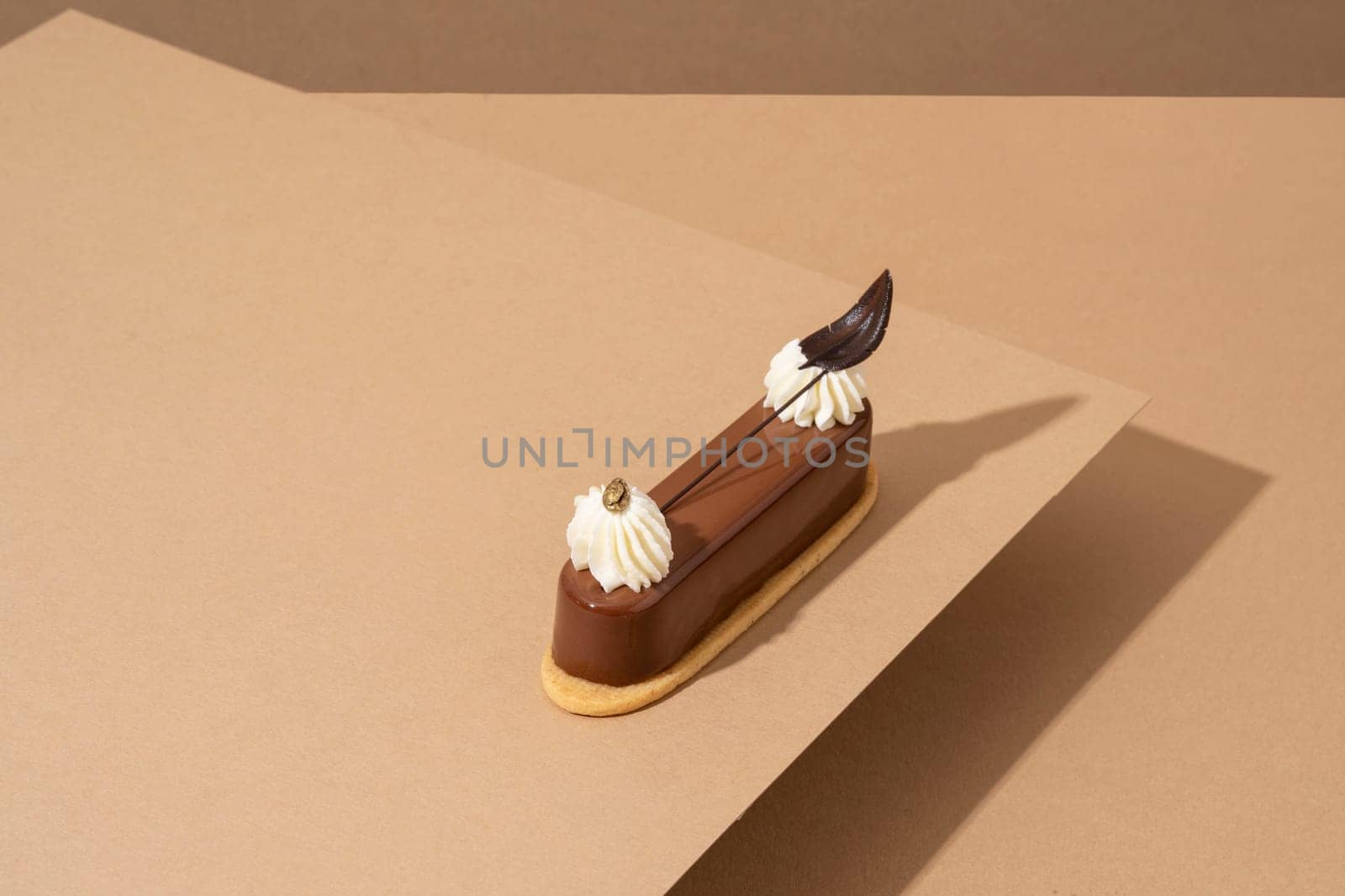 A freshly-baked cake sits atop a table, surrounded by sheets of parchment pape