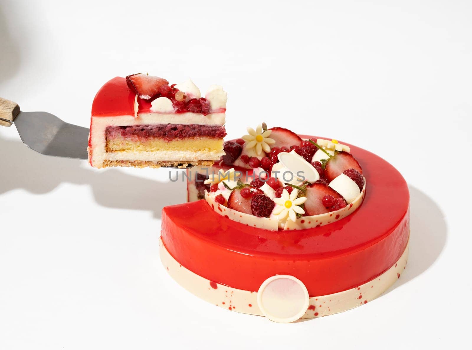 A strawberry cake with a fork while it is resting on a flat surface by A_Karim