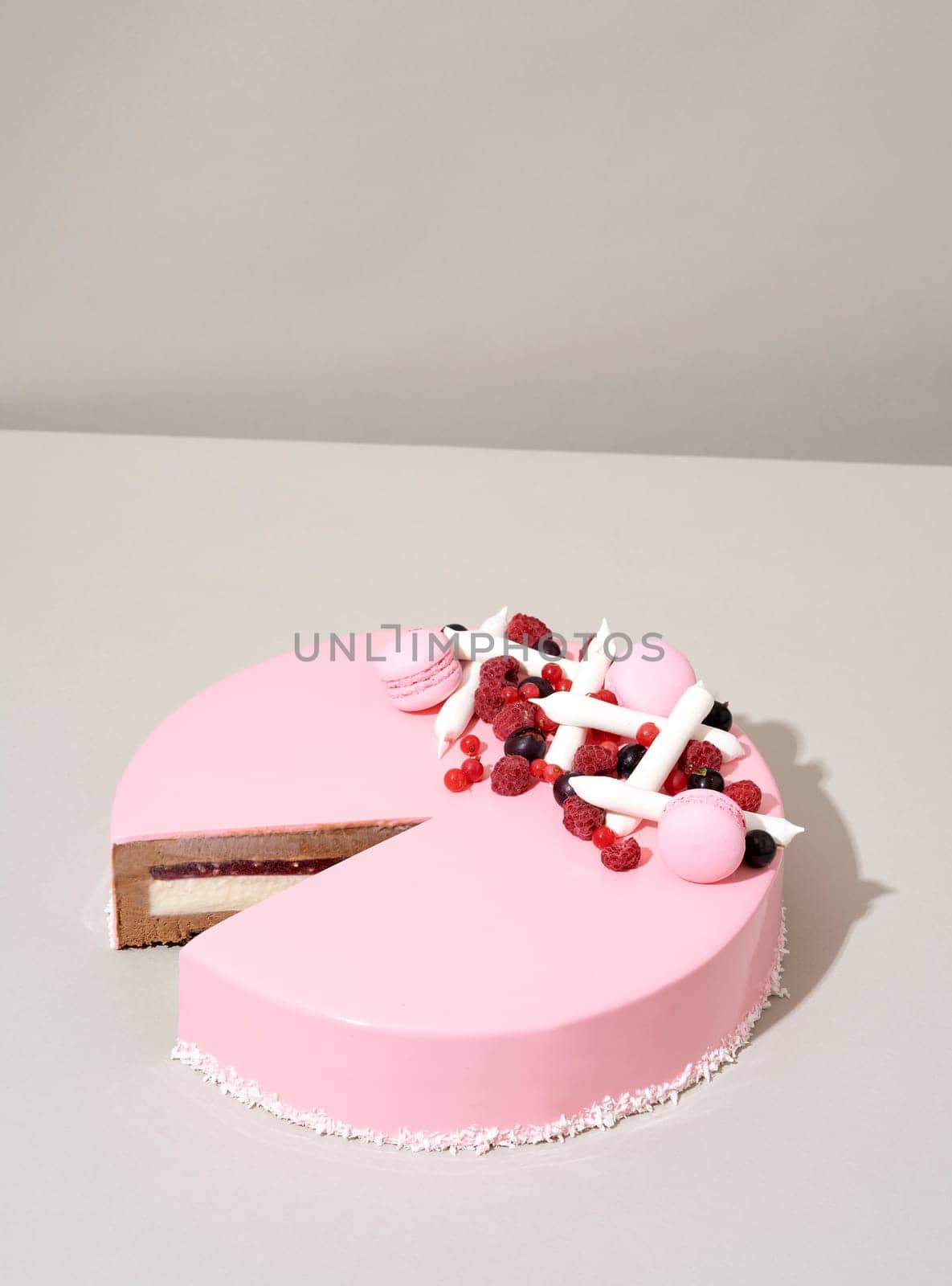 A close-up shot of a delectable cake featuring a raspberry and white chocolate topping by A_Karim