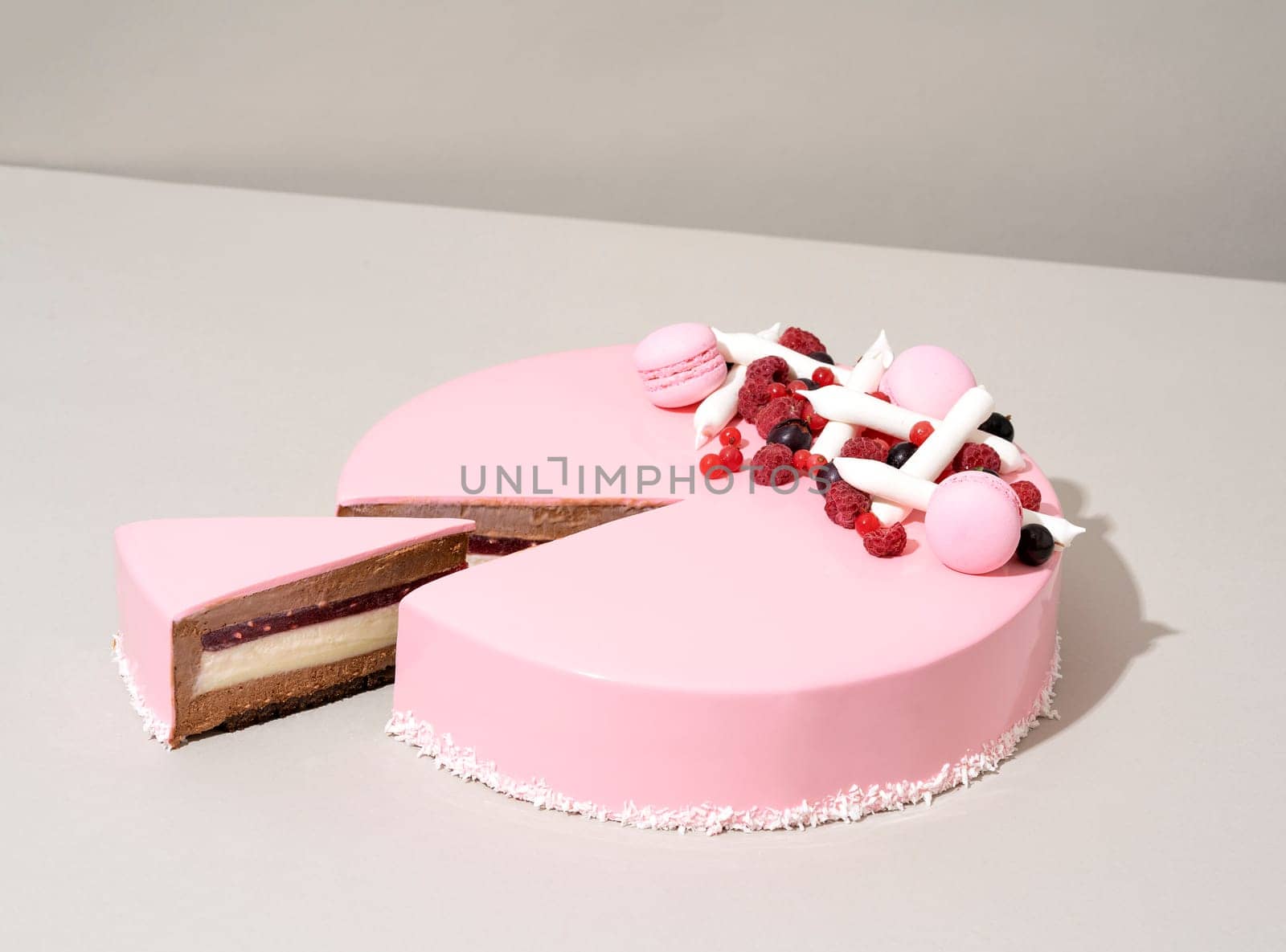 A close-up shot of a delectable cake featuring a raspberry and white chocolate topping