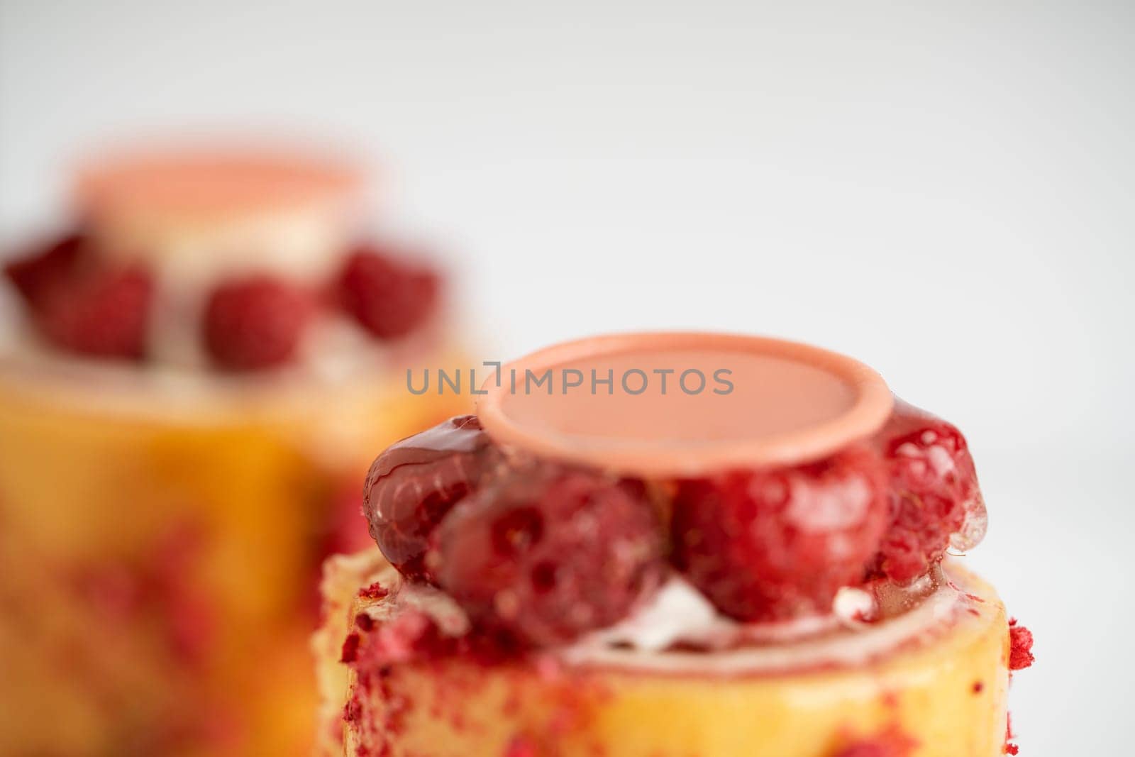 A delicious dessert of raspberry pudding topped with luscious cream and a sweet drizzle