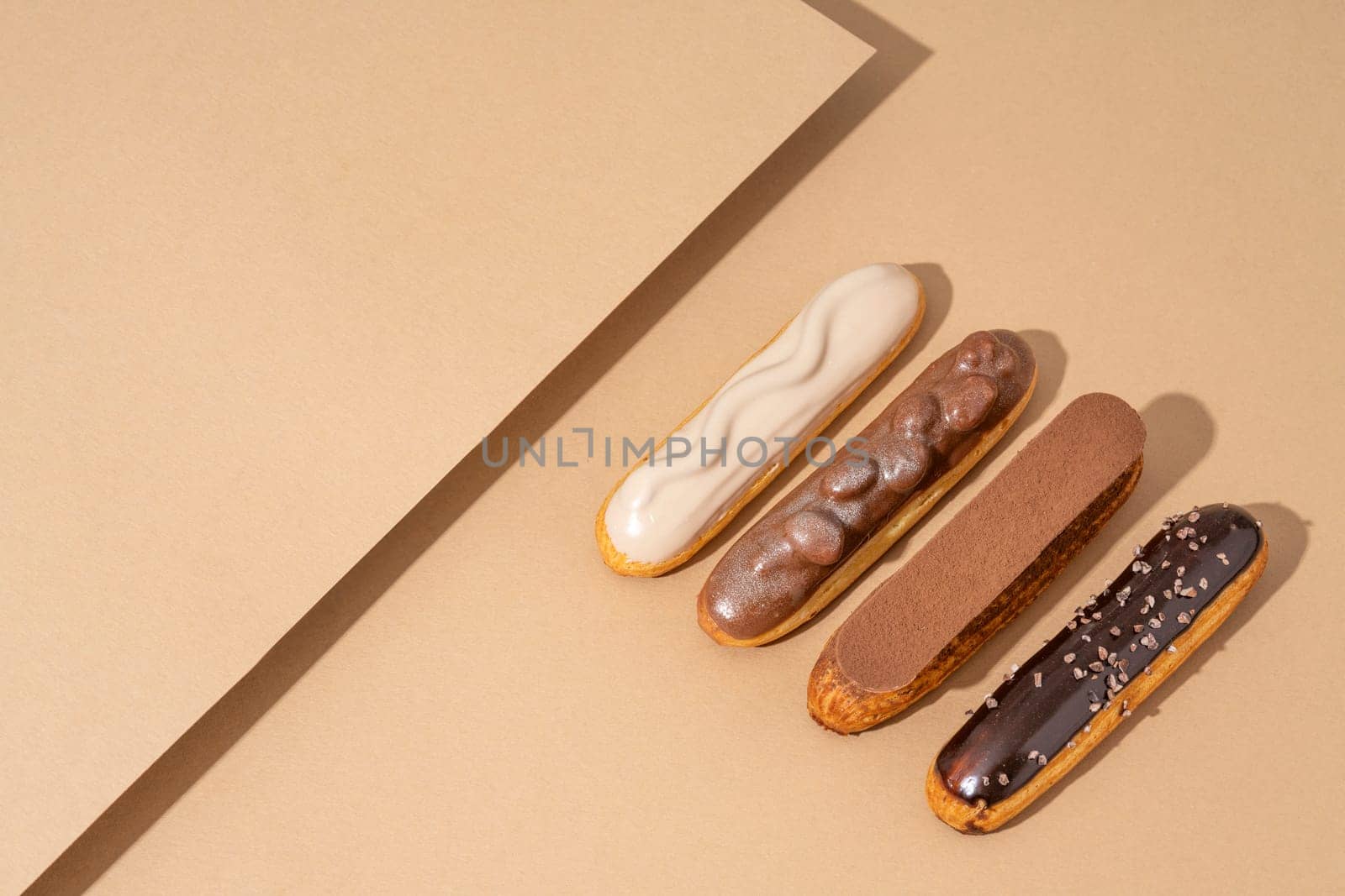 A set of delicious glazed donuts in a variety of flavors, arranged on a cardboard paper in an inviting display