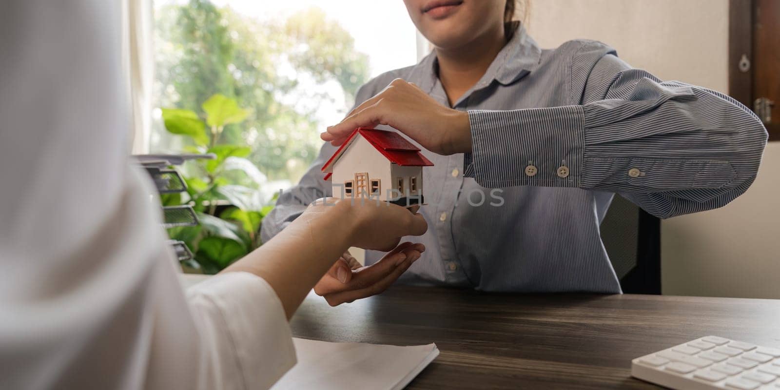 Property insurance, real estate broker or home insurance agent gesture protect house, contract document, security concept, protection. Insurance rent buy sell mortgage.