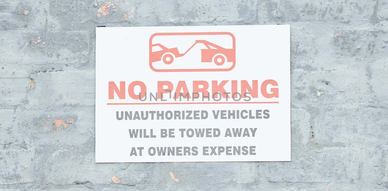 Warning, parking and stop with sign and towing icon on wall for forbidden, security and no. Transportation, prohibited and emergency with board for safety, private property and restriction banner.