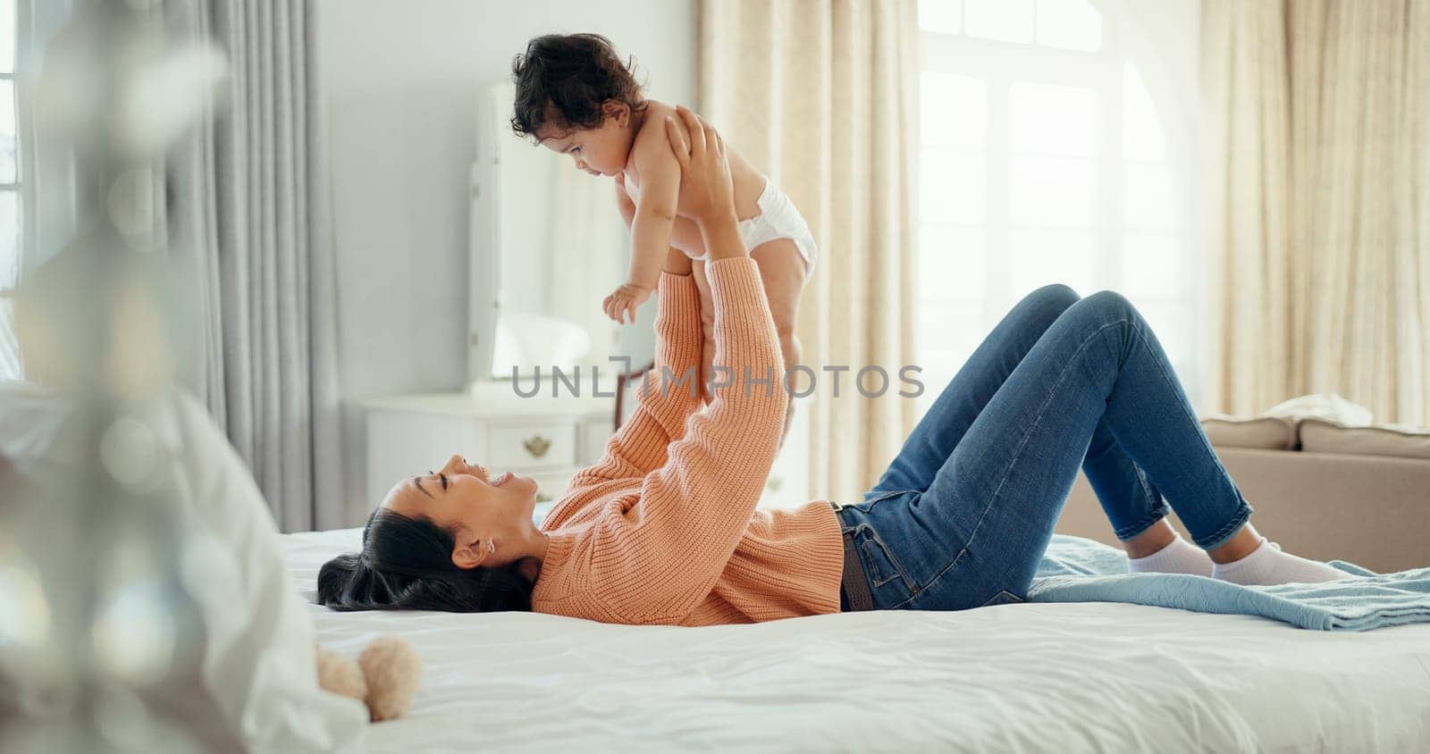 Relax, happy and mother with baby on bed for playful, love and free time. Happiness, smile and health with woman and newborn infant in bedroom for family home for support, excited and youth by YuriArcurs