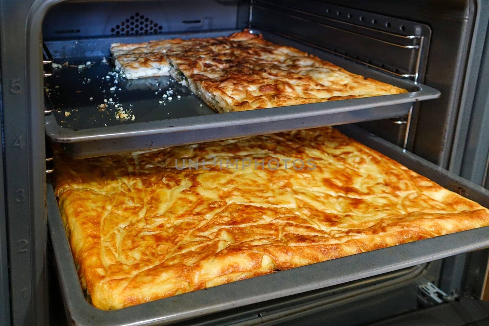 Turkish style water pastry baked in the oven, a tray full of pastries,