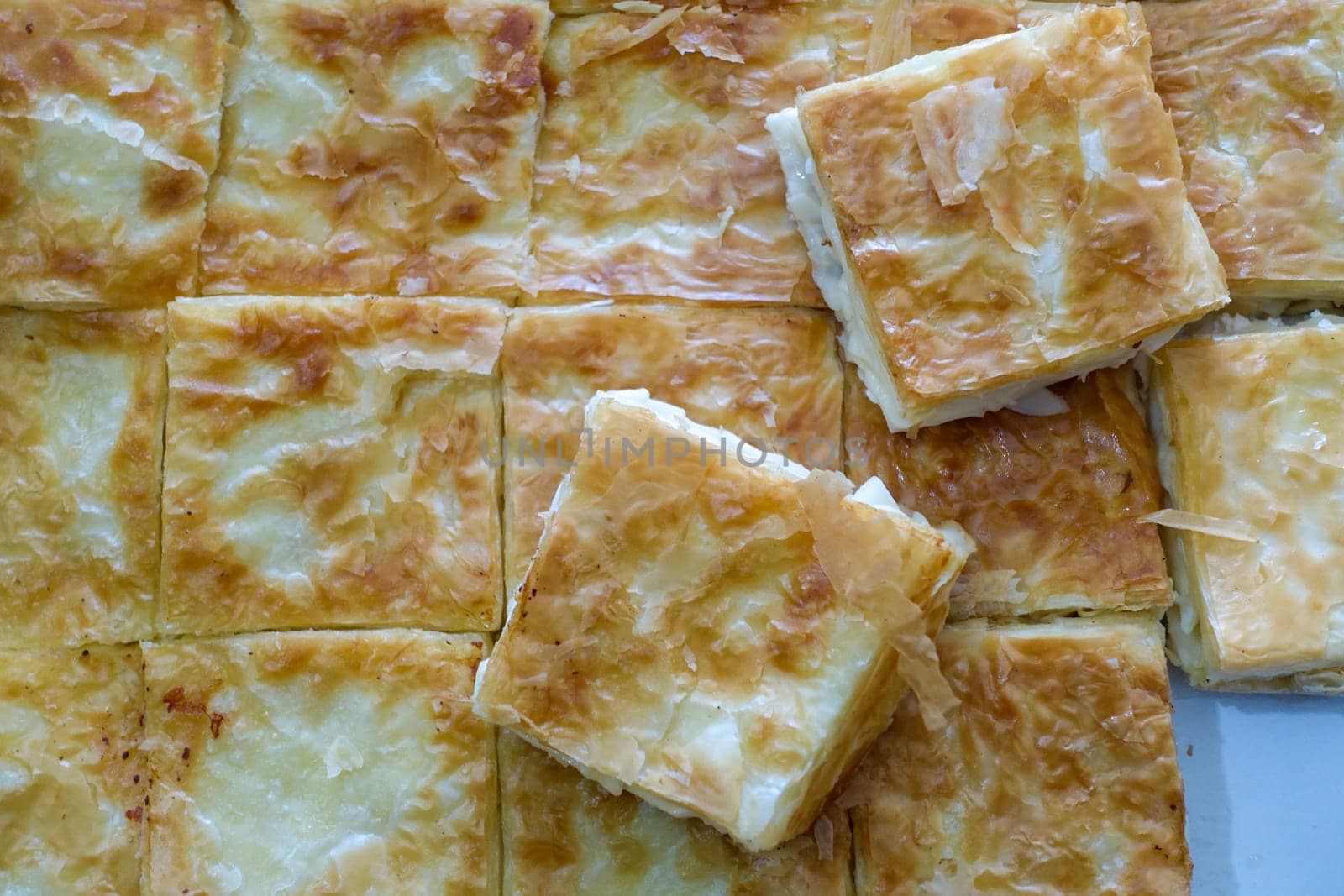 turkish style cheese pie, water pastry tray, serving börek, turkish style börek close-up, by nhatipoglu