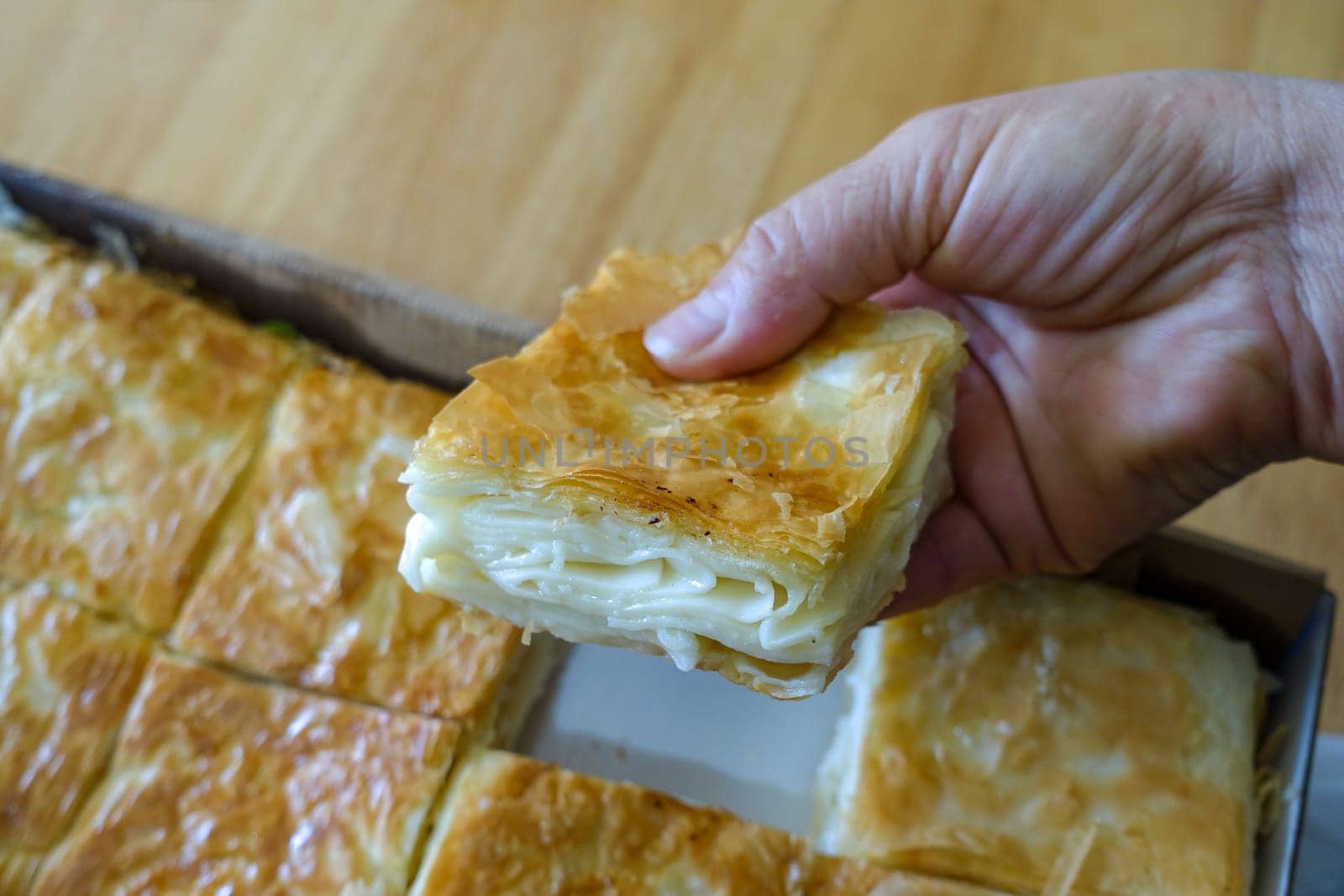 turkish style cheese pie, water borek turkish style close-up, cheese pie,a tray full of pastries, by nhatipoglu