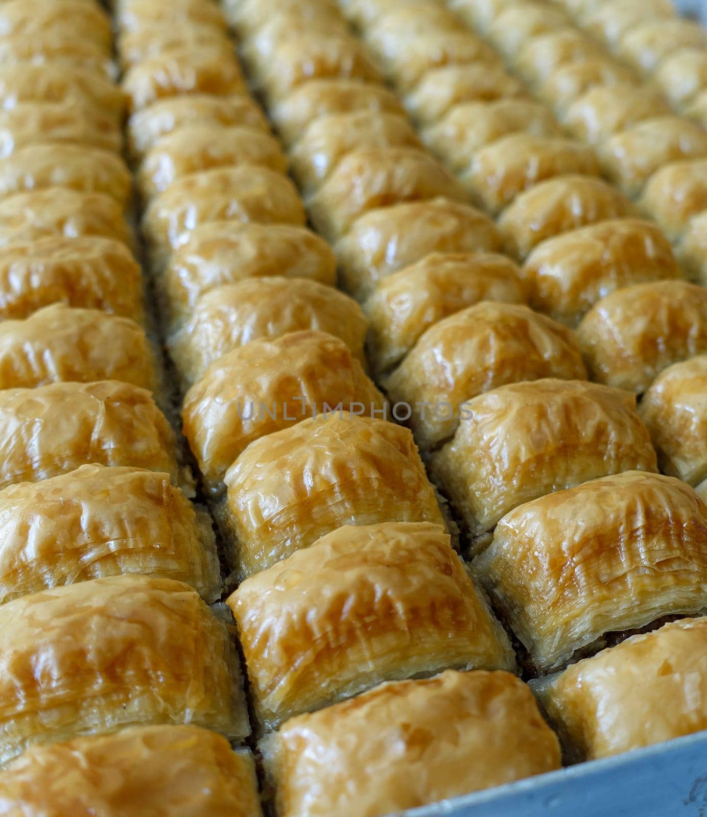 Famous Turkish baklava dessert sliced in a baking tray, Gaziantep baklava,