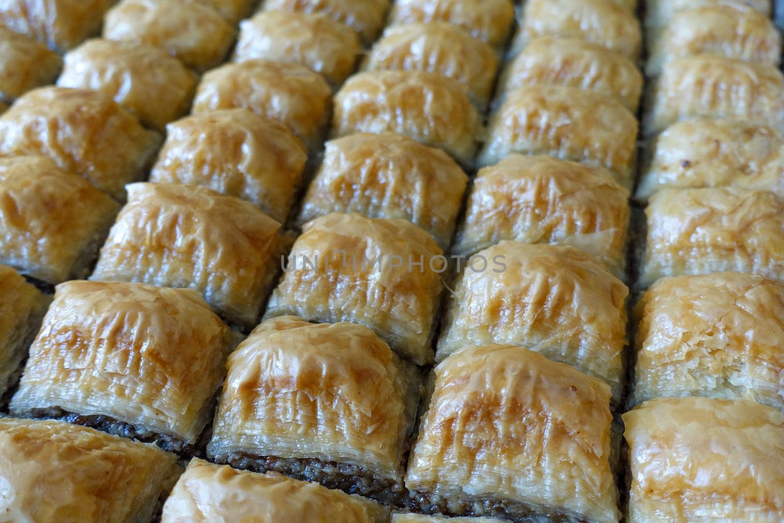 Famous Turkish baklava dessert sliced in a baking tray, Gaziantep baklava, by nhatipoglu