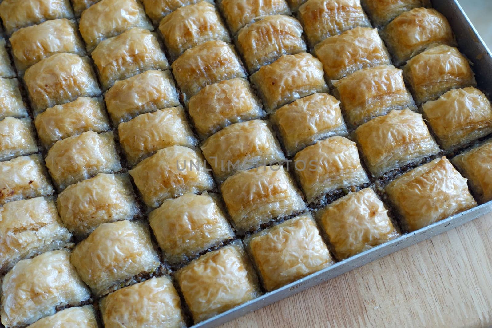 Famous Turkish baklava dessert sliced in a baking tray, Gaziantep baklava,