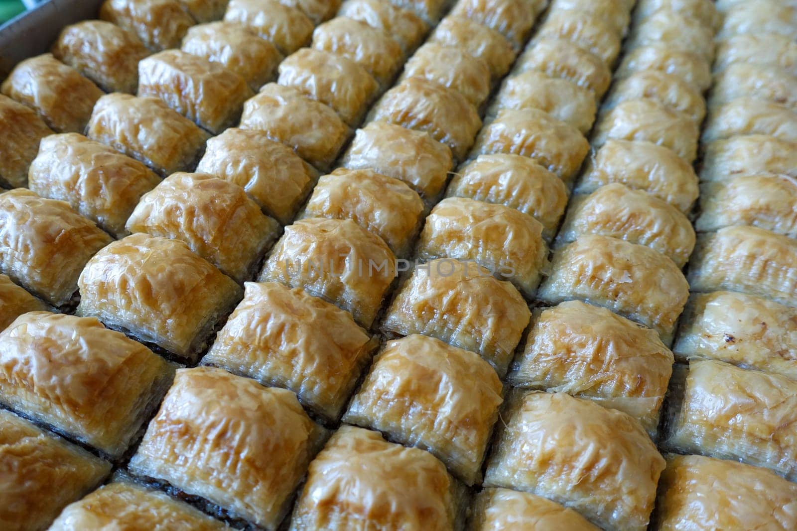 Famous Turkish baklava dessert sliced in a baking tray, Gaziantep baklava, by nhatipoglu