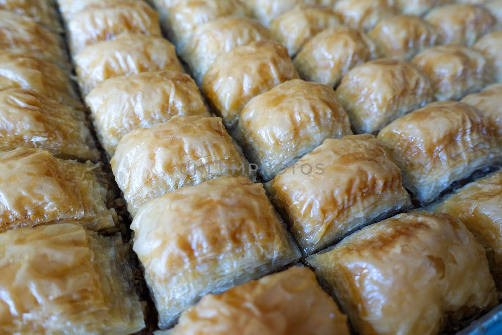 Famous Turkish baklava dessert sliced in a baking tray, Gaziantep baklava, by nhatipoglu