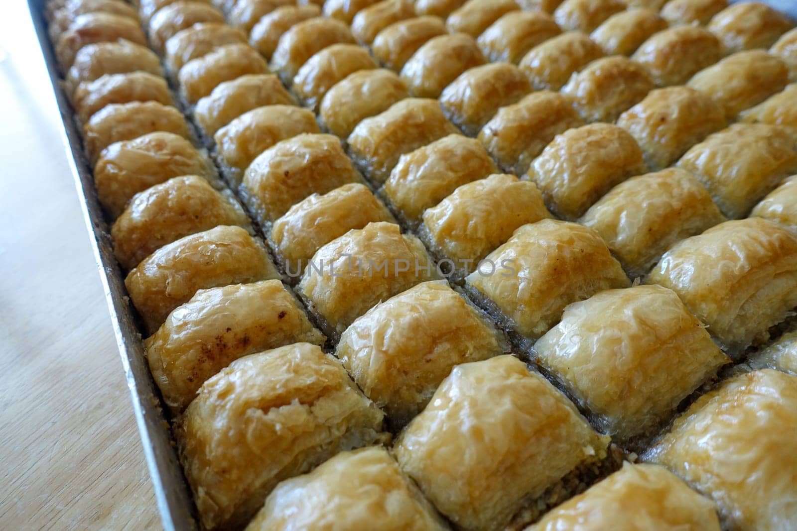 Famous Turkish baklava dessert sliced in a baking tray, Gaziantep baklava, by nhatipoglu