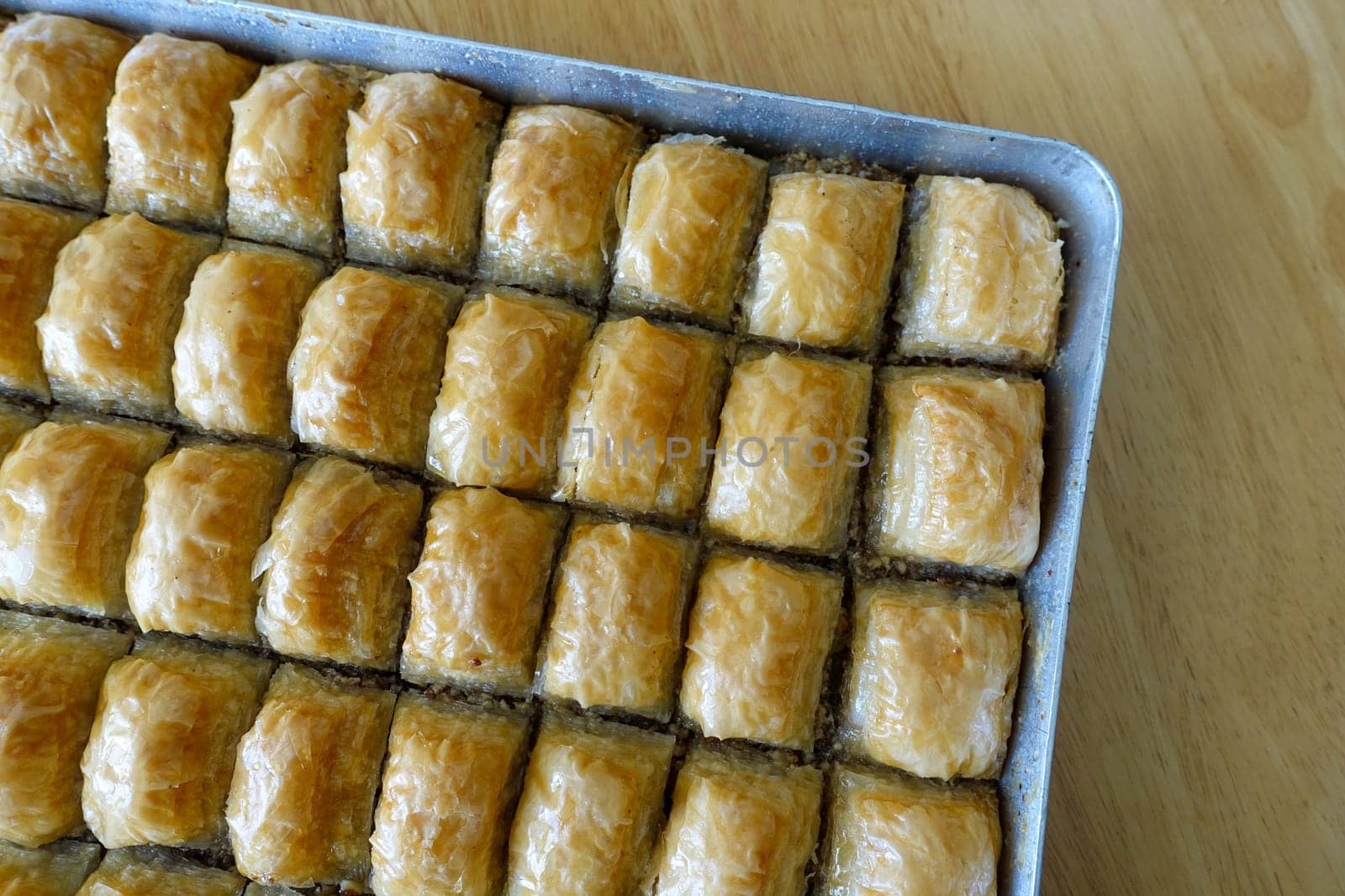 Famous Turkish baklava dessert sliced in a baking tray, Gaziantep baklava,