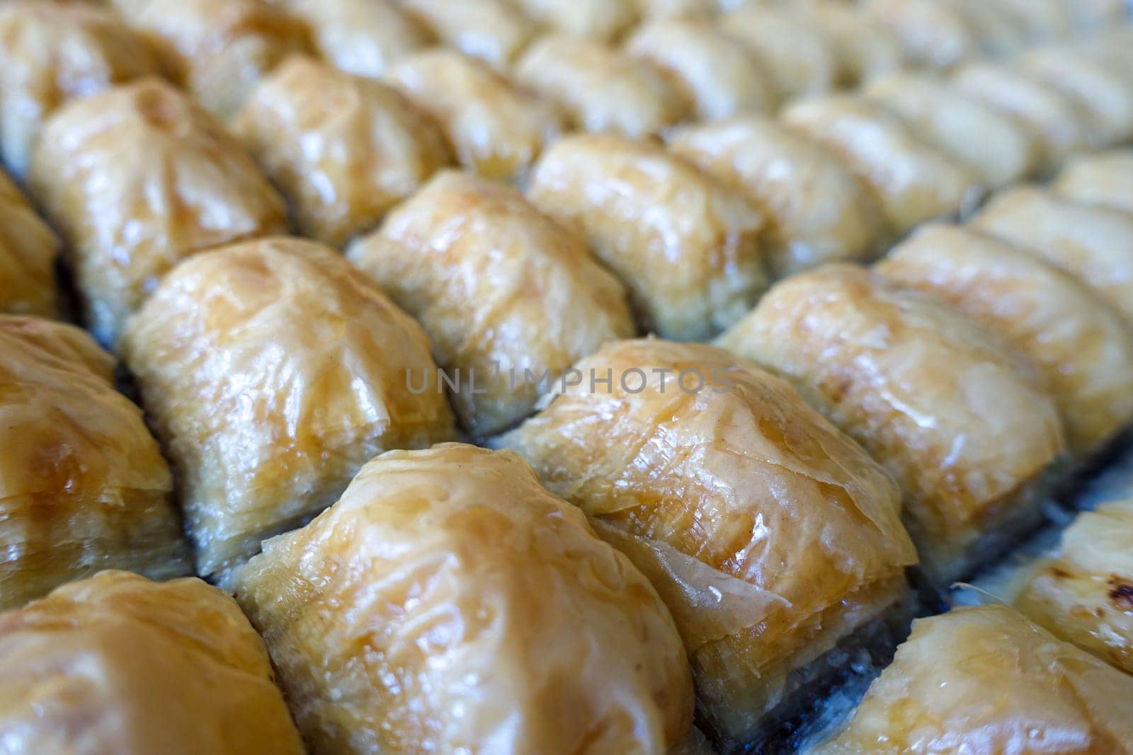 Famous Turkish baklava dessert sliced in a baking tray, Gaziantep baklava, by nhatipoglu