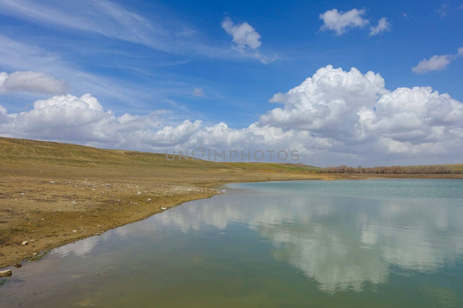 wonderful spring landscape of sky lake and clouds,clouds reflecting in water,