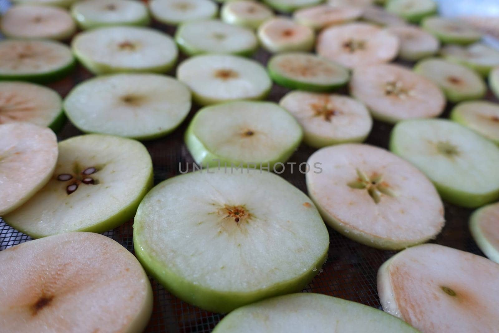 apple drying process,close-up sliced apple slices left to dry, by nhatipoglu