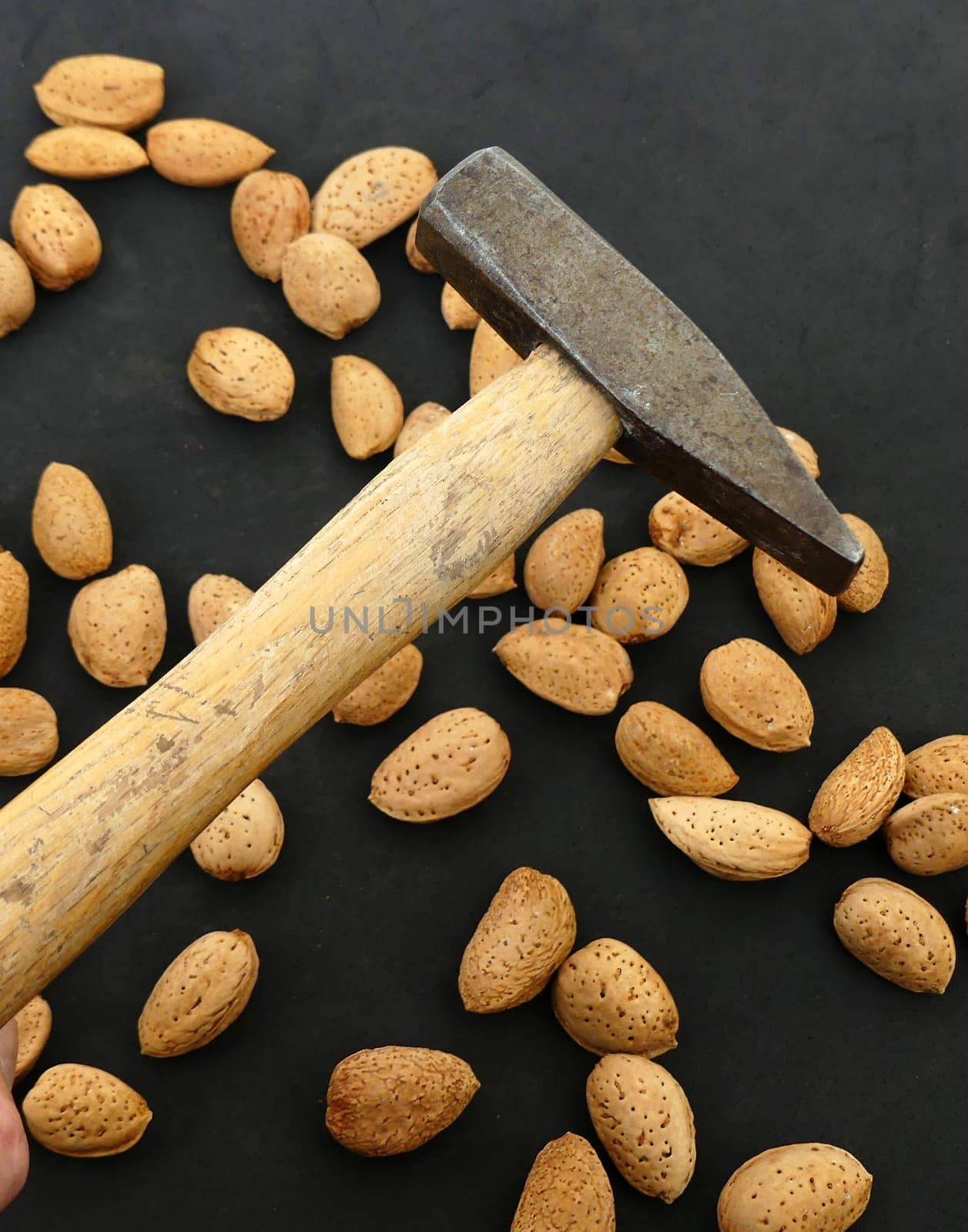 break dry shelled almonds with hammer. hammer and dry almonds,