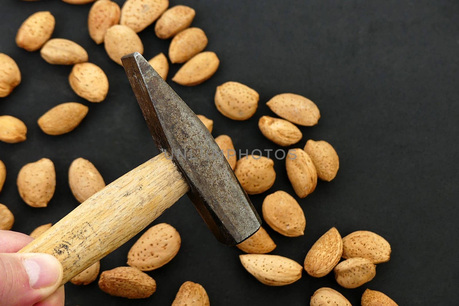 break dry shelled almonds with hammer. hammer and dry almonds,