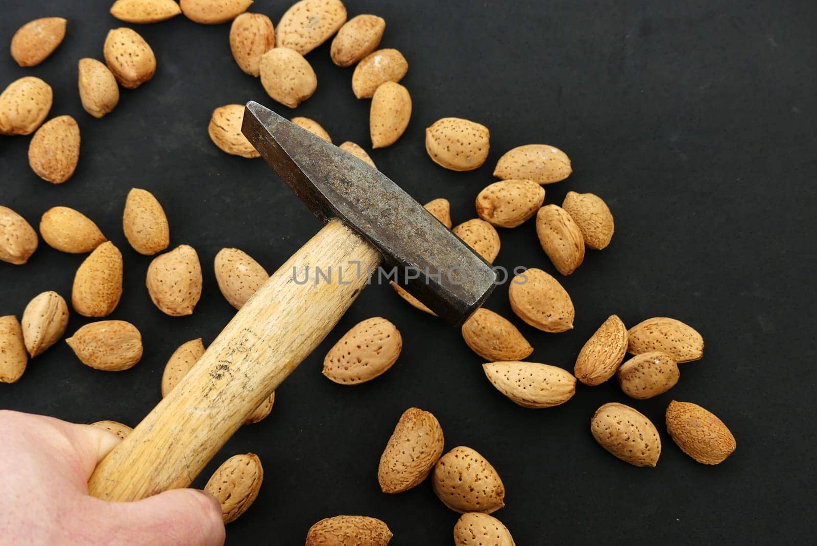 break dry shelled almonds with hammer. hammer and dry almonds,