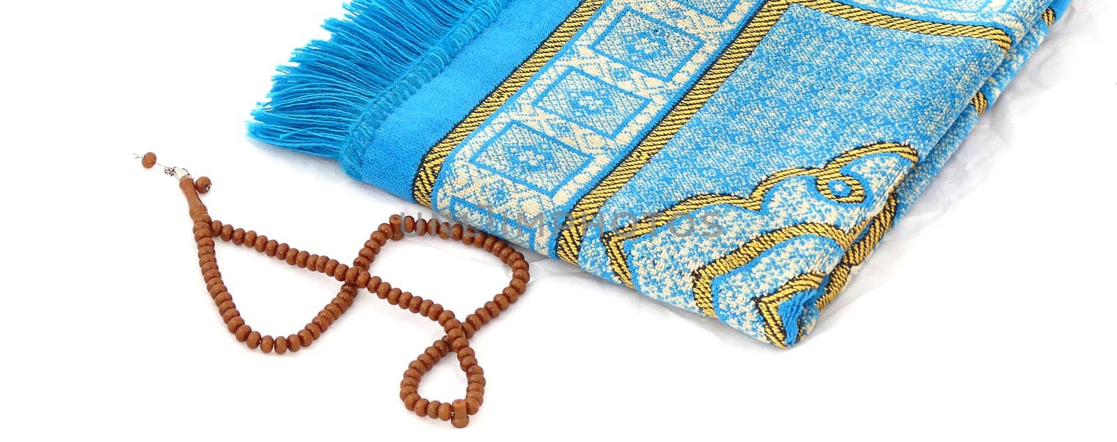 close-up prayer rug and rosary, Islam and prayer rug, on the prostration Muslims pray on,