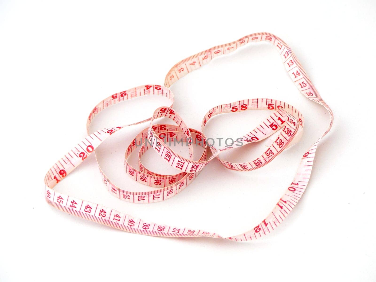 close-up tailor's tape measure,rope tape measure on a white background, by nhatipoglu