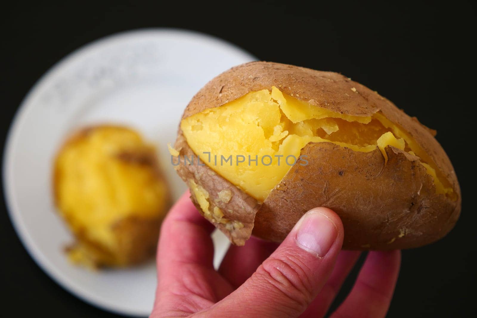 close-up of boiled whole potatoes in the plate,boiled large potatoes with the peel, by nhatipoglu