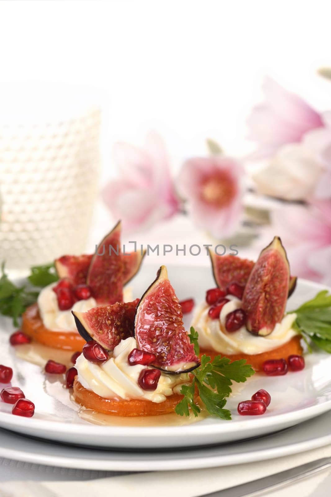 Roasted sweet potato rounds as a vegetarian snack. Perfect for a festive feast, they are topped with creamy whipped yogurt feta, juicy figs and honey and pomegranate. Vegetarian Gluten Free