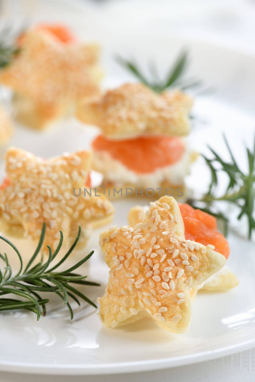 Festive appetizer of puff pastry in the shape of a star, stuffed with salmon and soft cheese. The perfect appetizer for your holiday table.