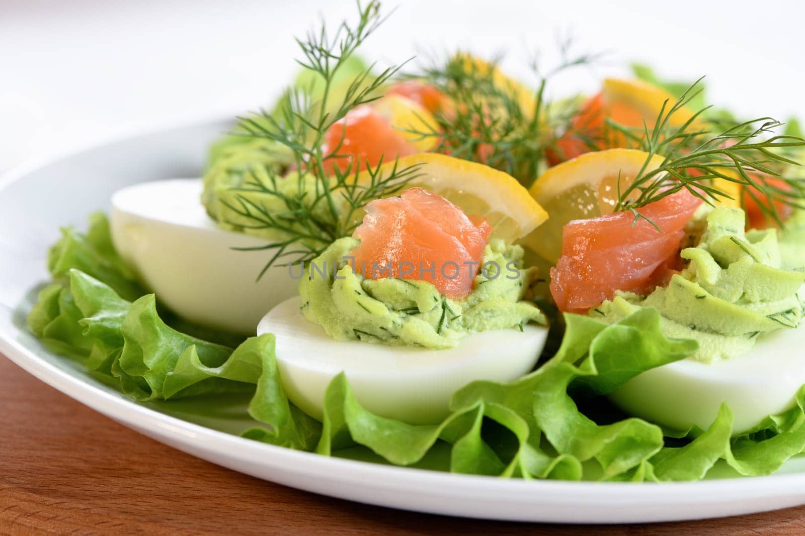 Eggs stuffed with avocado, salmon and lemon. The perfect appetizer for your holiday table.