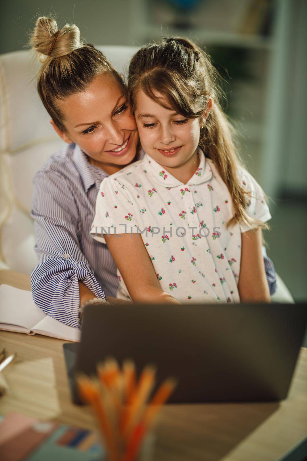 Shot of a cute little girl and her beautiful young mother using laptop over a video call during COVID-19 pandemic.