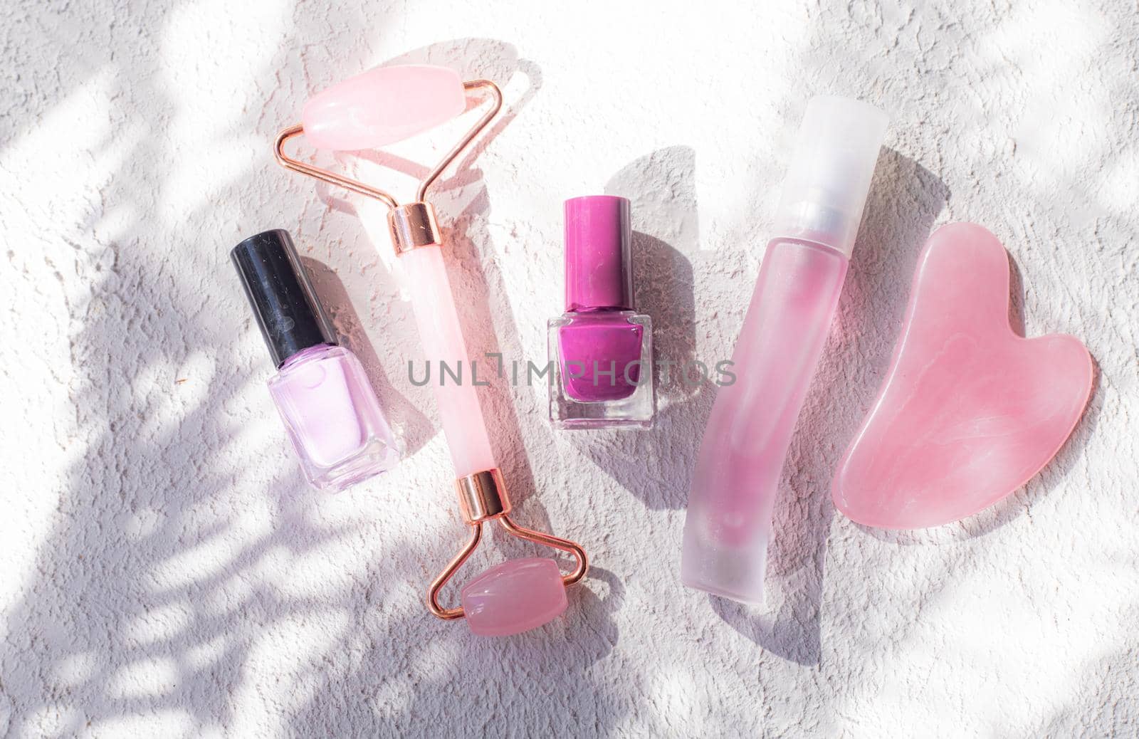 The layout of cosmetics and sun rays . Cosmetics and shadows. Decorative cosmetics. Cosmetology. Beauty and fashion.