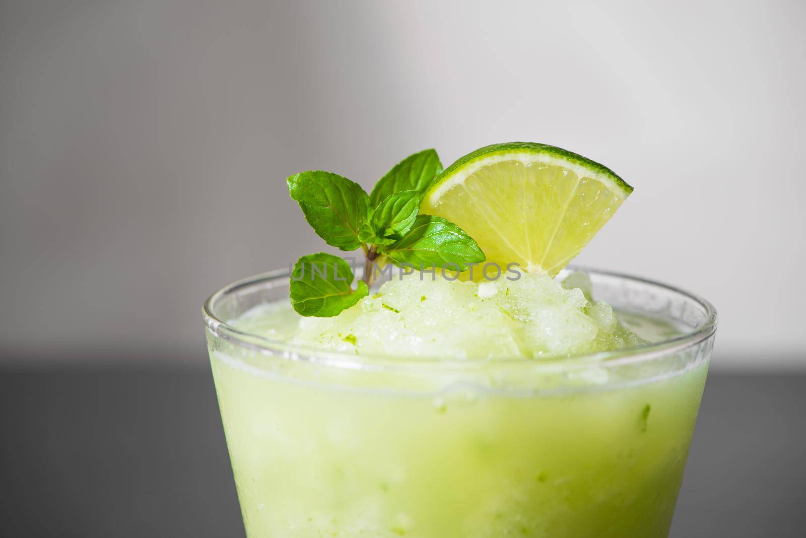 Cocktail juice with lime, mint and ice. Bar drink accessories on black table background. by makidotvn